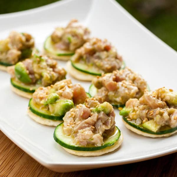 tuna tartar on cucumber rounds and rice crackers