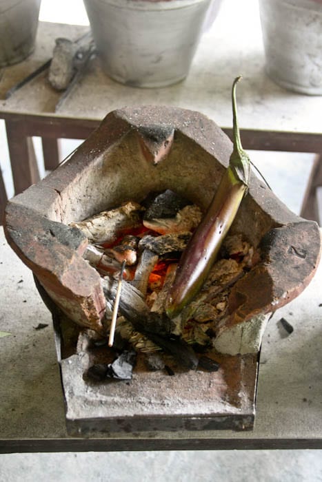 Eggplant being charred over coals