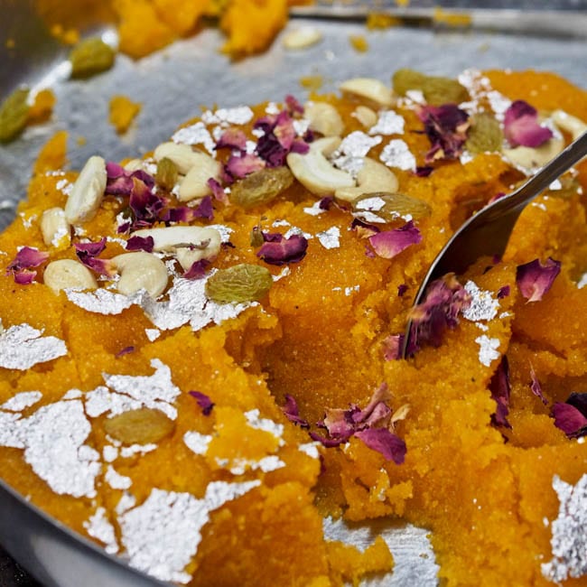 Rava Kesari topped with rose petals and dried fruit and nuts
