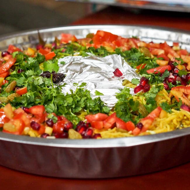 vegetable biryani garnished with herbs and spices