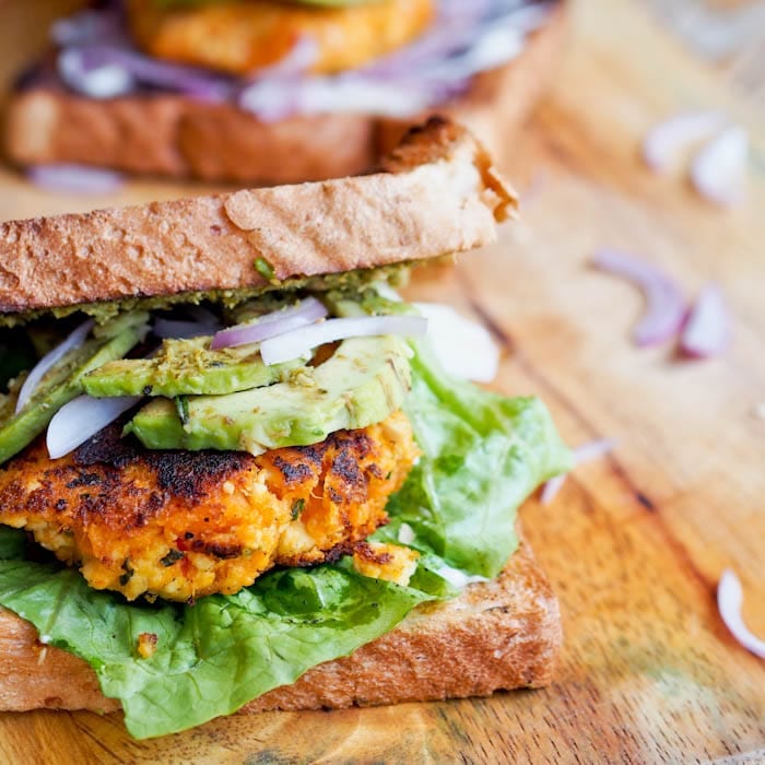 Tofu burger with avocados, red onions and lettuce
