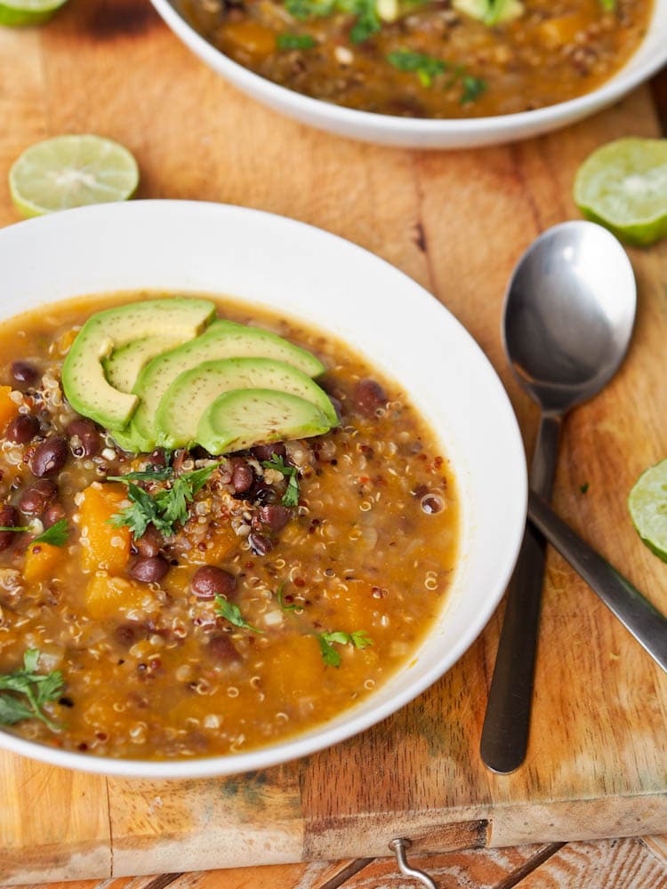 Black Bean Pumpkin Soup with quinoa served garnished with fresh avocado