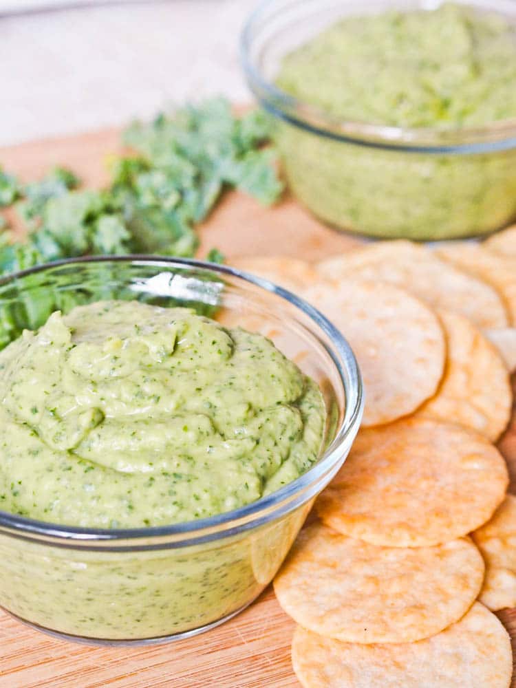 vegan white bean dip with kale served with rice crackers
