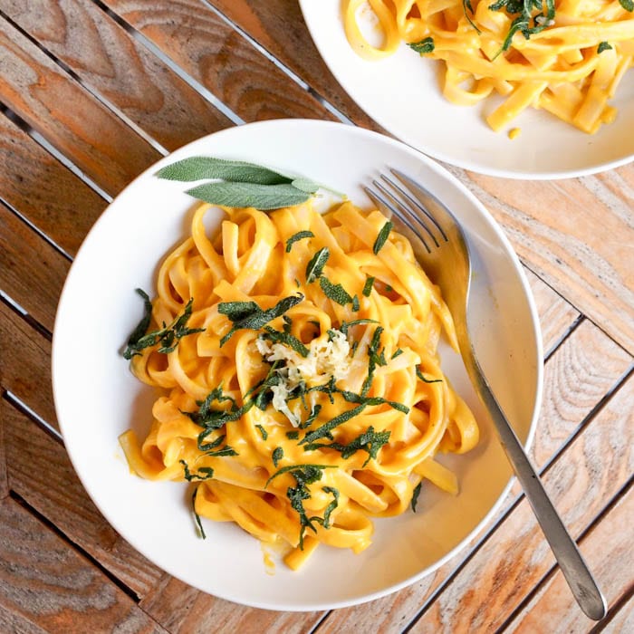 Vegan Pumpkin Pasta is made with pumpkin and coconut milk & makes for a quick and simple fall themed weeknight dinner. Gluten Free and low in fat. No heavy cream necessary for a rich and velvetty pasta sauce. | avocadopesto.com