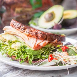 The best turkey, arugula, alfalfa and avocado sandwich you'll ever eat. Topped with a spicy Sriracha Aioli. Lunch is served. Gluten Free + Dairy Free too. |avocadopesto.com