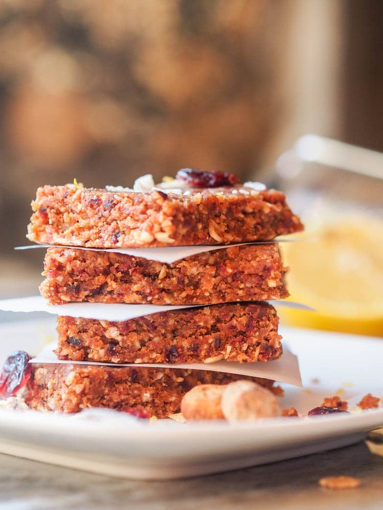 Vegan Energy Bars with Coconut, Macadamia and Cranberries stacked on top of eachother