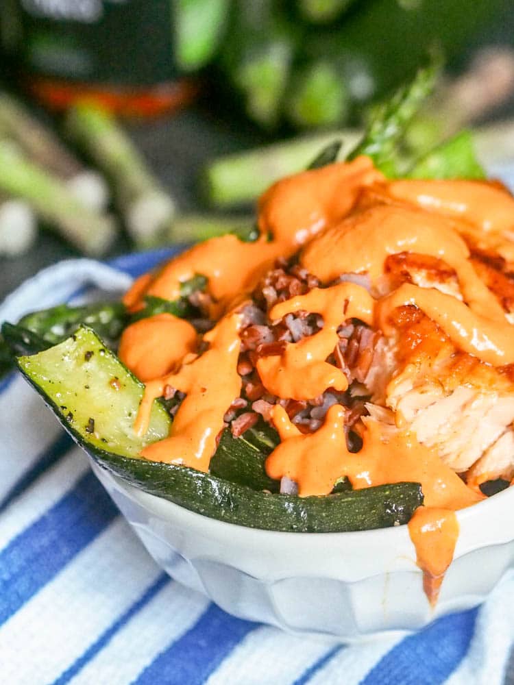 salmon rice bowl topped with roasted red pepper sauce