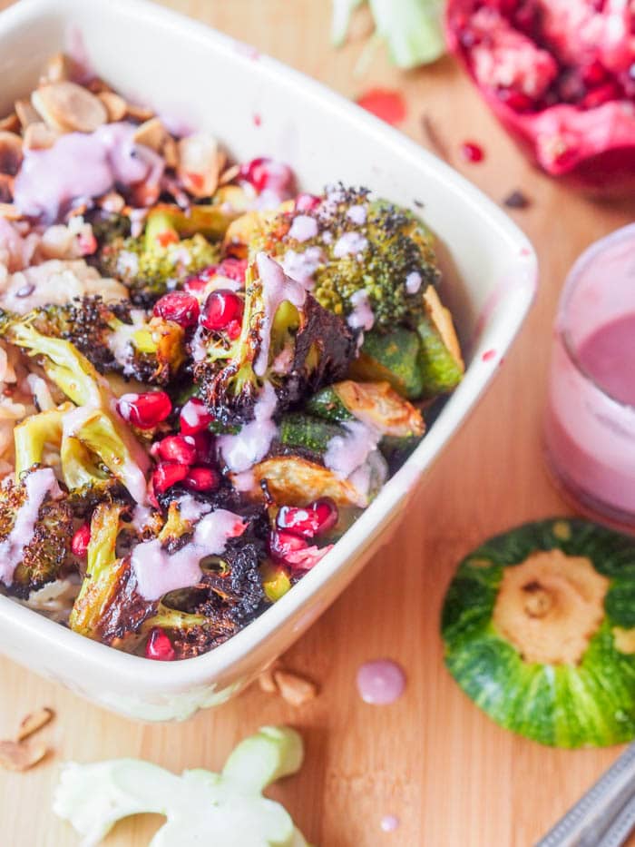 Super colorful and nutrient packed vegan wild rice green bowls with roasted broccoli, and zucchini, toasted almonds, pomegranate arils, and a vibrant pomegranate coconut sauce. Ultimate flavor combination. Easy to make and healthy. Perfect for dinner. Gluten Free too. 