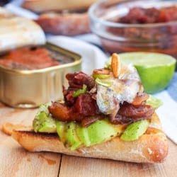 Sardine Toast with avocado, tomato relish and garlic chips makes for a perfect summer lunch or light dinner. Inspired by Portuguese cuisine, a must try, super hearty healthy and omega 3 loaded dish. Gluten Free + Dairy Free | avocadopesto.com