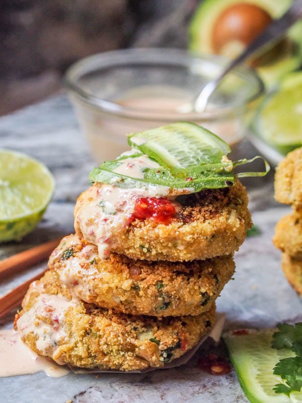 asian tuna cakes drizzled with kimchi aioi and topped with avocado and cucumber slices
