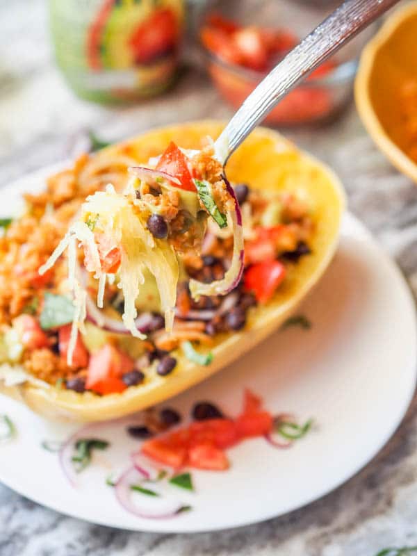 A forkful loaded with all the toppings for stuffed spaghetti squash taco bowls