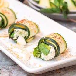Your new favorite no cook appetizer - healthy, light and delicious paleo + vegan zucchini rolls with home made herbed cashew ricotta, mint, avocado and crushed almonds. GF. | avocadopesto.com
