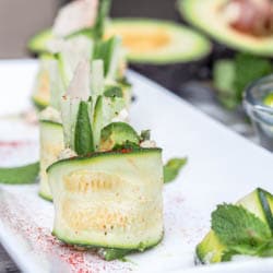 Super light and refreshing 20 minute 6 ingredient low carb zucchini rolls with hummus, chicken, cucumber, mint and avocado make for the perfect party appetizer or light meal. Gluten Free + Dairy Free too. | avocadopesto.com