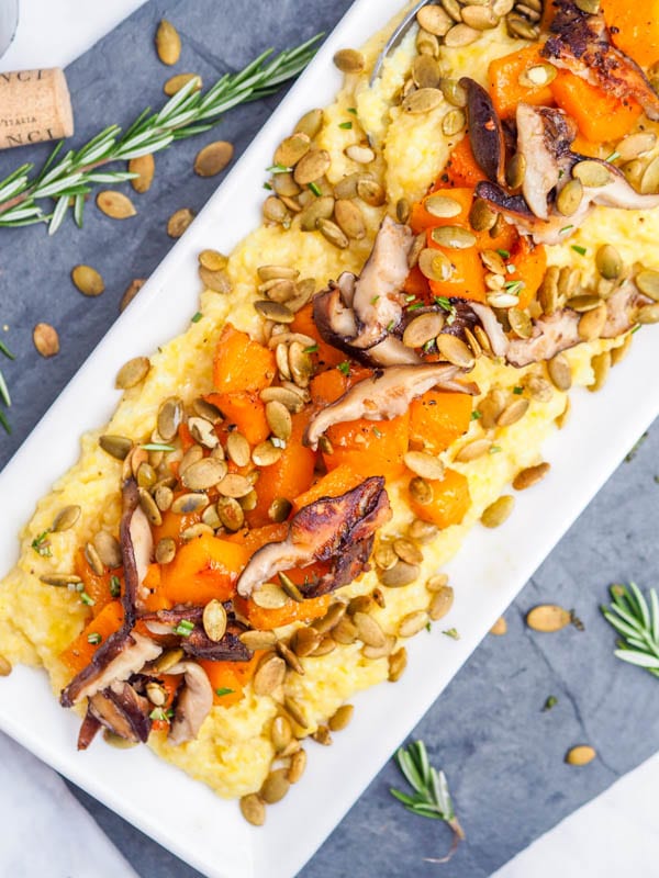 Creamy Polenta with Shiitakes Roasted Squash and Pumpkin Seeds in a large serving dish