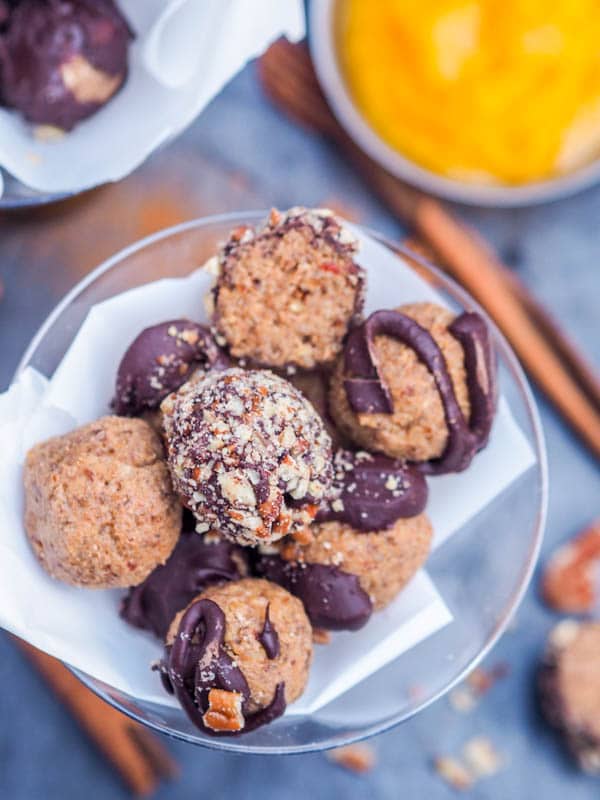 Whole Pumpkin Pie Truffles drizzled with melted chocolate and dipped in crushed pecans