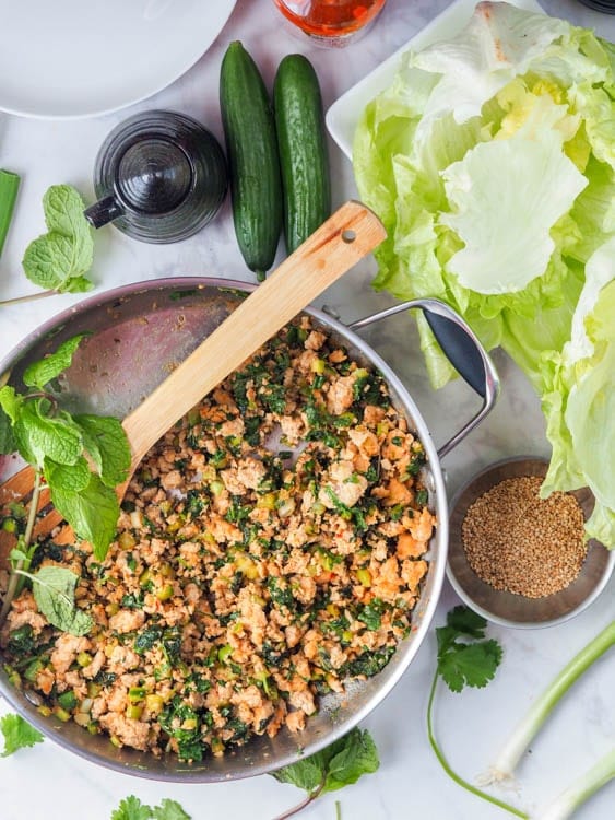 ground chicken in the skillet with spices and seasoning for the asian chicken lettuce wraps