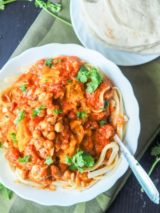 big plate of pasta with chicken and chickpeas in a creamy tomato, pumpkin and yogurt sauce