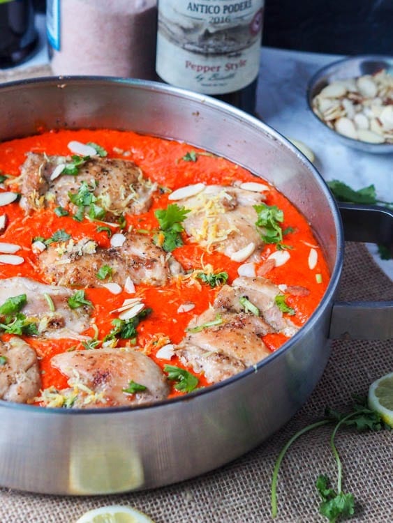 paleo chicken in a skillet with a roasted red pepper sauce 