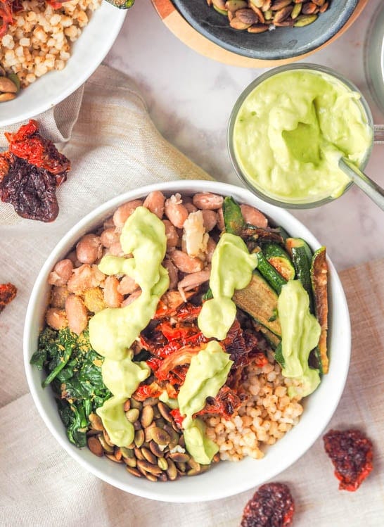 Sorghum Buddha Bowl assembled with veggies and topped with avocado sauce
