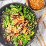 Tempeh Stir Fry makes for an easy Asian themed healthy dinner ready in under 30 minutes. Made with Gailan and mushrooms, topped with a creamy spicy tahini sauce. Gluten Free and Vegan.