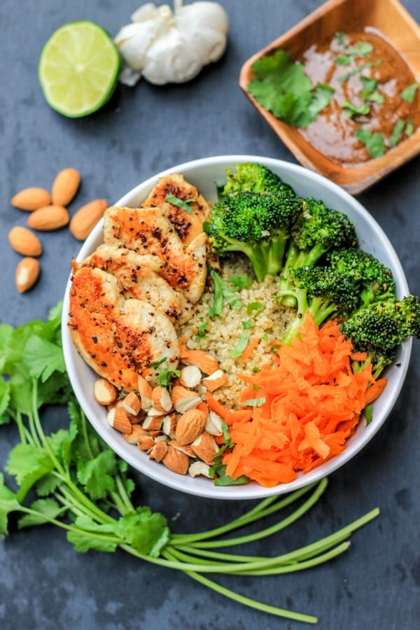 chicken quinoa bowl with almond butter sauce on the side